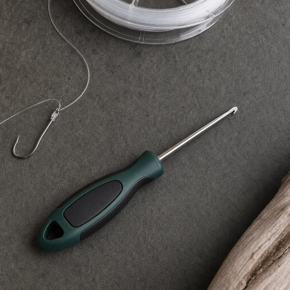 A generic hook remover laid out with fishing line on a neutral background.