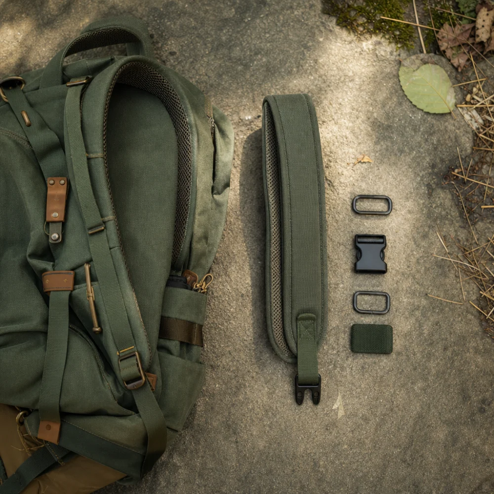 A generic replacement backpack strap with simple hardware laid out on a neutral surface.