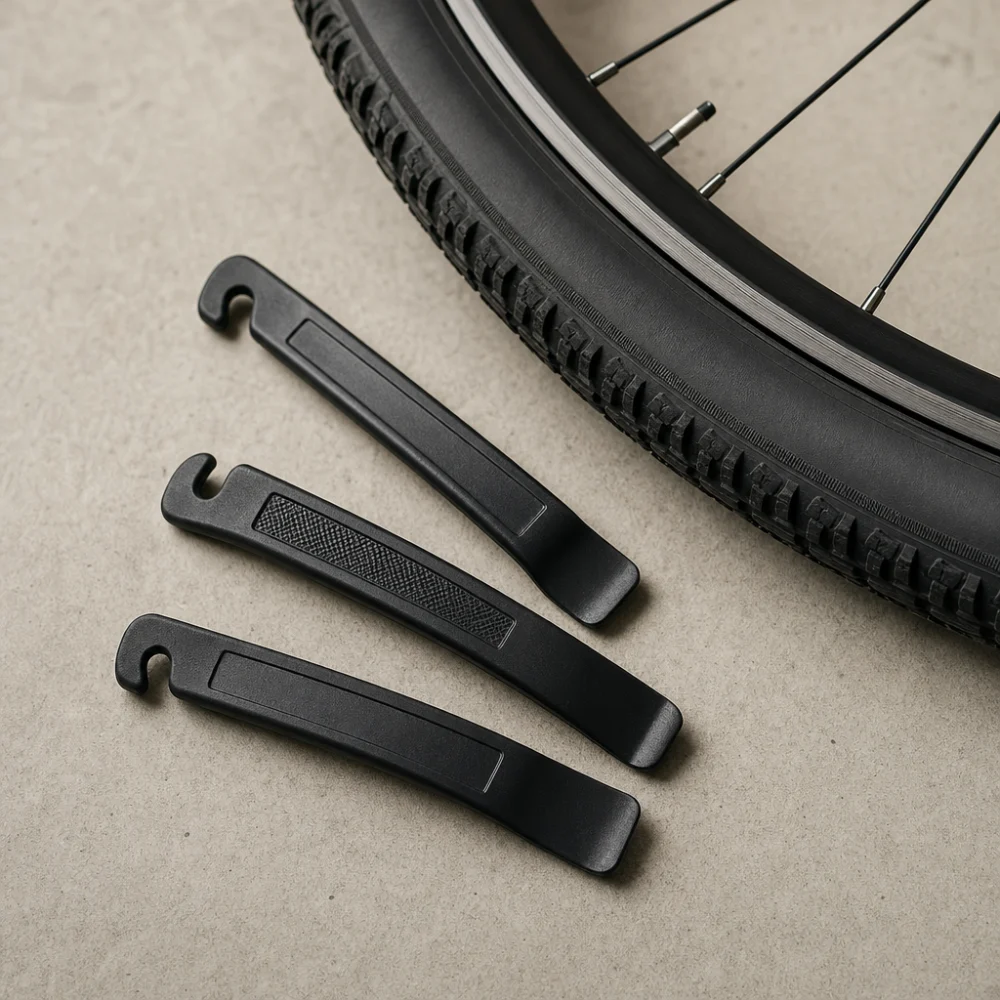 Generic tire levers laid out near a bicycle wheel and tire