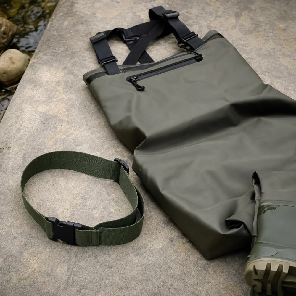 A wading belt shown beside folded fishing waders on a neutral surface.